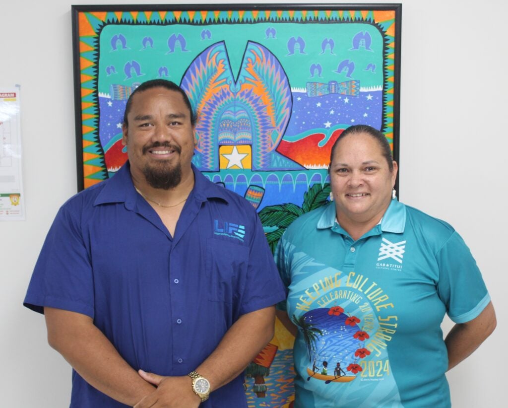 LIFE Founder Corey Ward with TSRA’s Nicole Assan stand infront of a bright Torres Strait Islander artwork to promote financial workshops in the Torres Strait region.