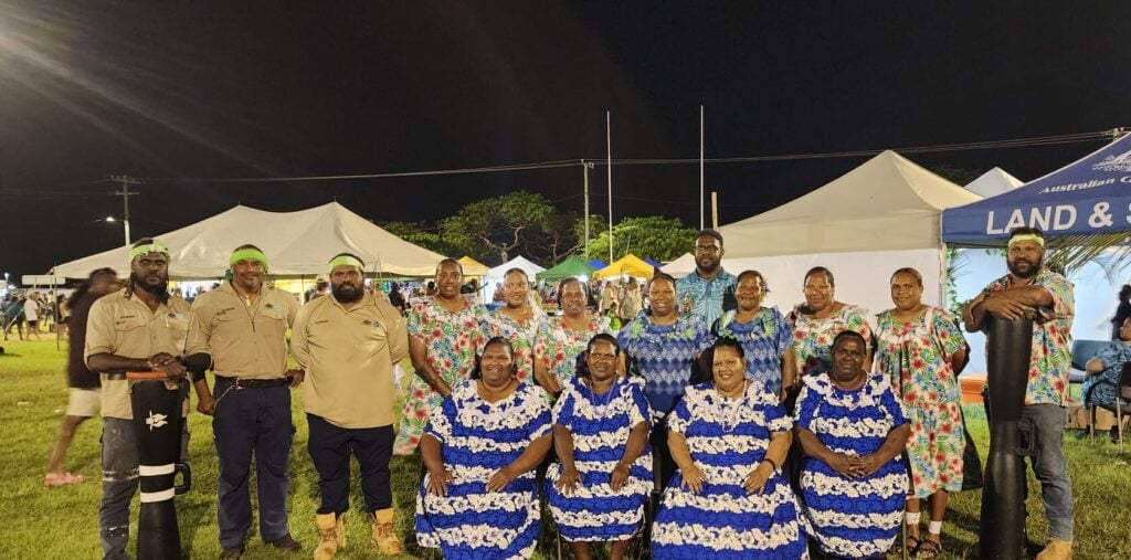 TSRA Rangers with Mabuaig Island singers and composer Lency Bani on Ken Brown Oval on Thursday Island in the Torres Strait region for the Winds of Zenadth Cultural Festival.