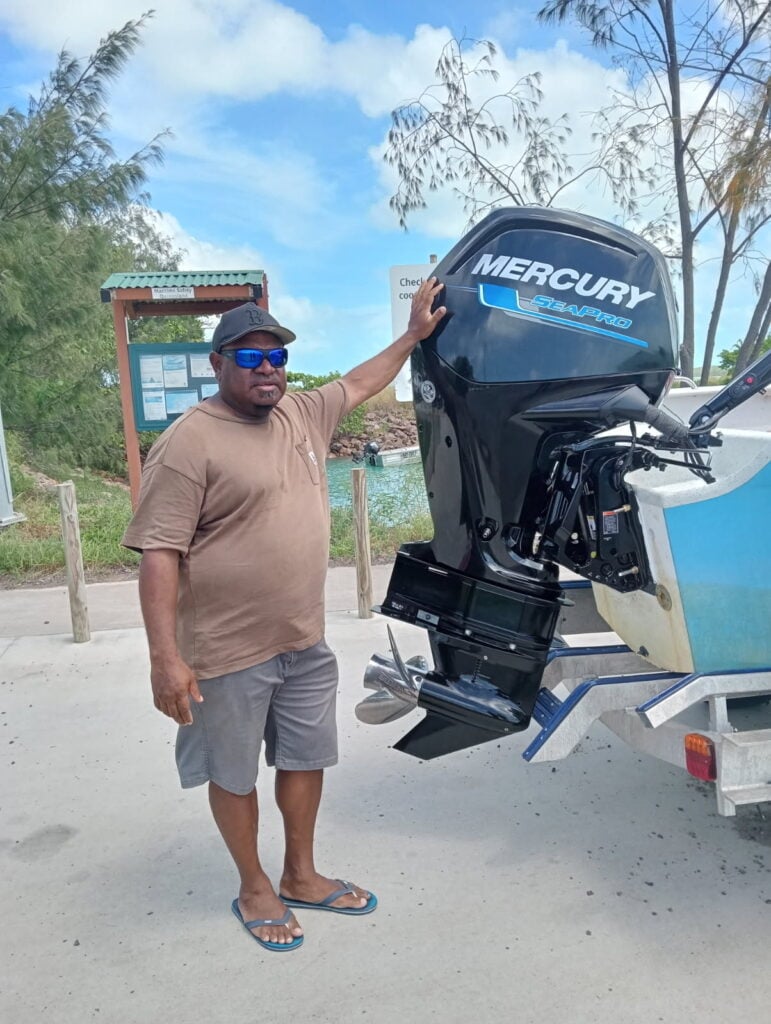 Torres Strait commercial fisher David Baragud pictured with his new outboard motor.