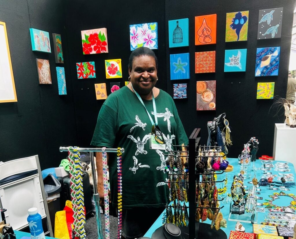 Artist Anna Solomon assisting at the GTCC Artisans booth.