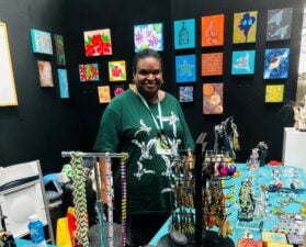 Artist Anna Solomon assisting at the GTCC Artisans booth.