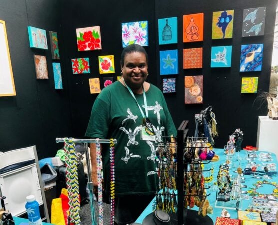 Artist Anna Solomon assisting at the GTCC Artisans booth.
